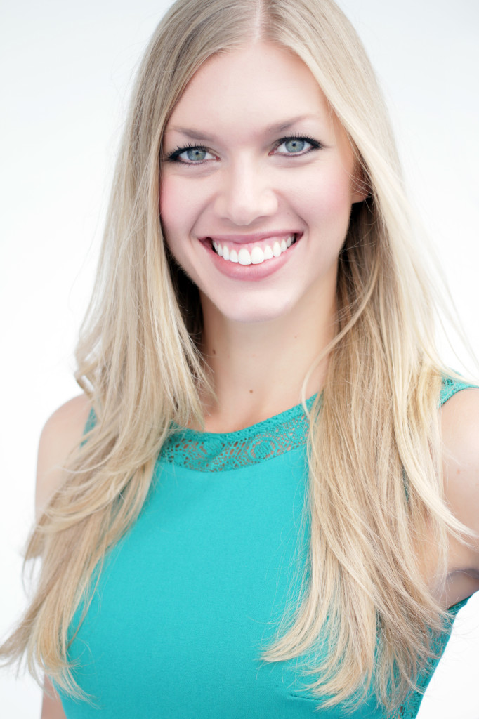 A woman with long blonde hair and blue eyes.