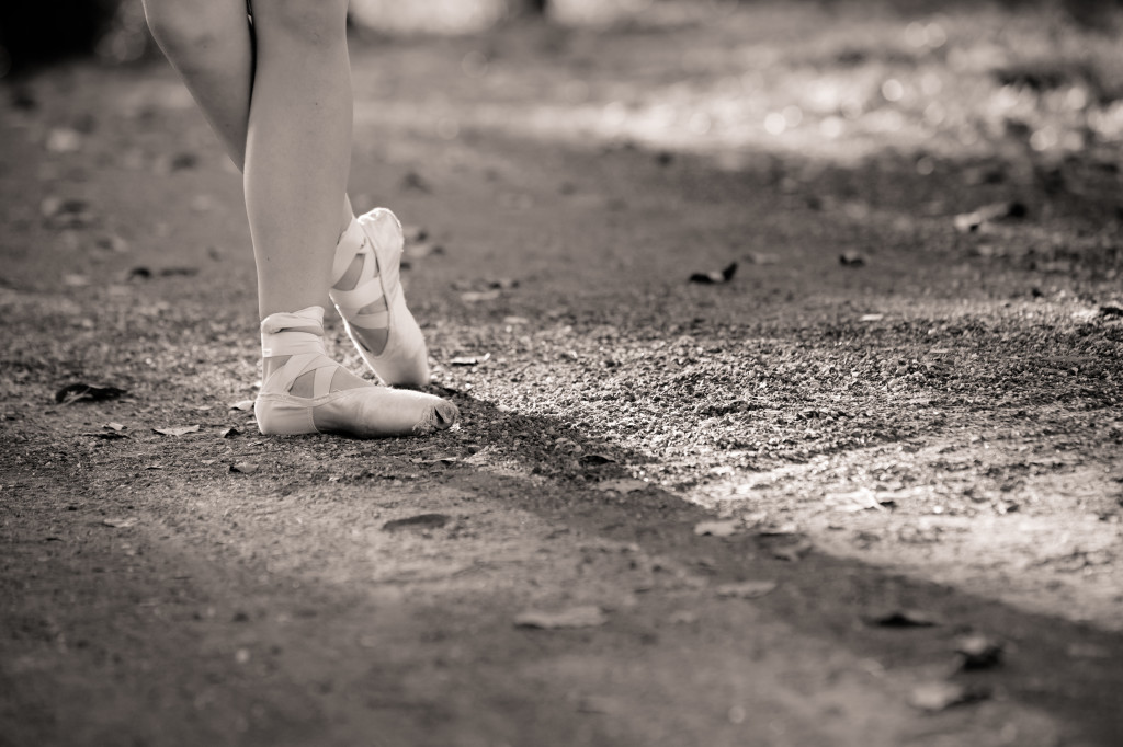 A person with white shoes standing on the ground.